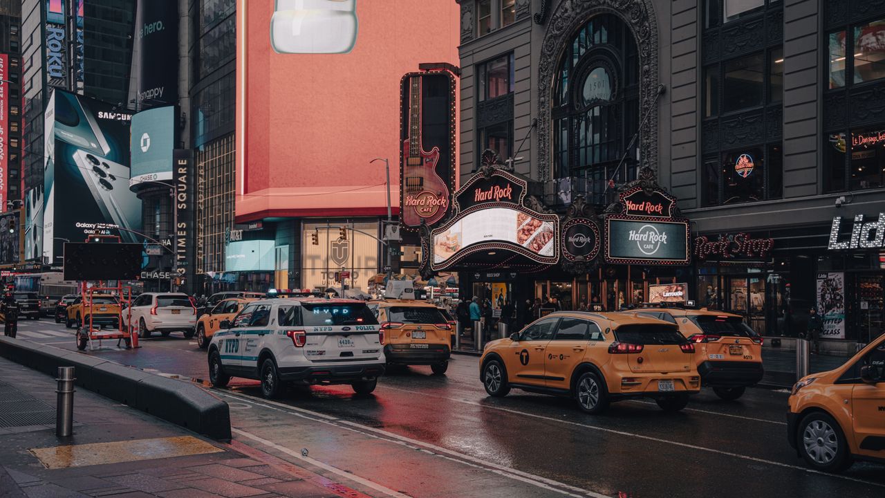 Mastering the First Impression: Your intriguing post title goes here Vibrant street view of Times Square, New York City featuring taxis, billboards, and urban architecture.